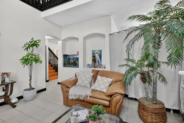 a living room with furniture and a potted plant