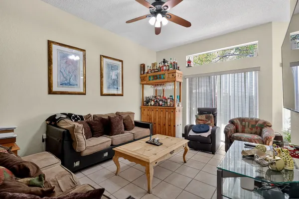 a living room with furniture fireplace and a large window