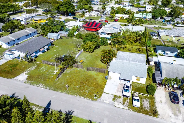an aerial view of residential houses with outdoor space and street view