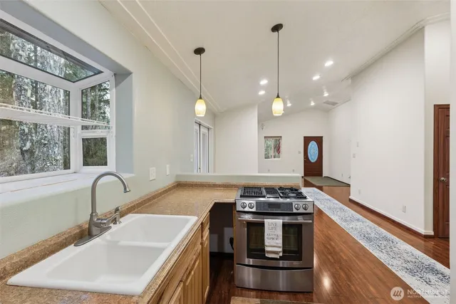 a kitchen that has a sink and a stove