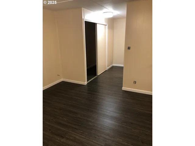 a view of a room with wooden floor