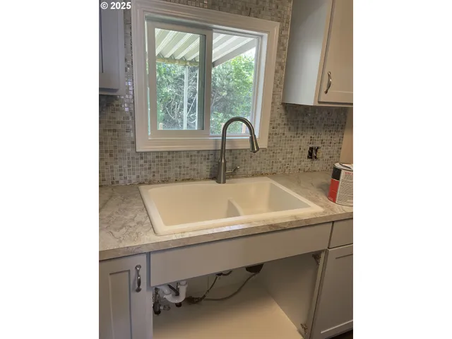 a bathroom with a sink and a window