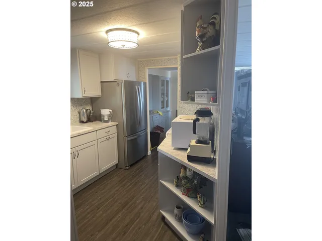 a kitchen with a refrigerator and cabinets
