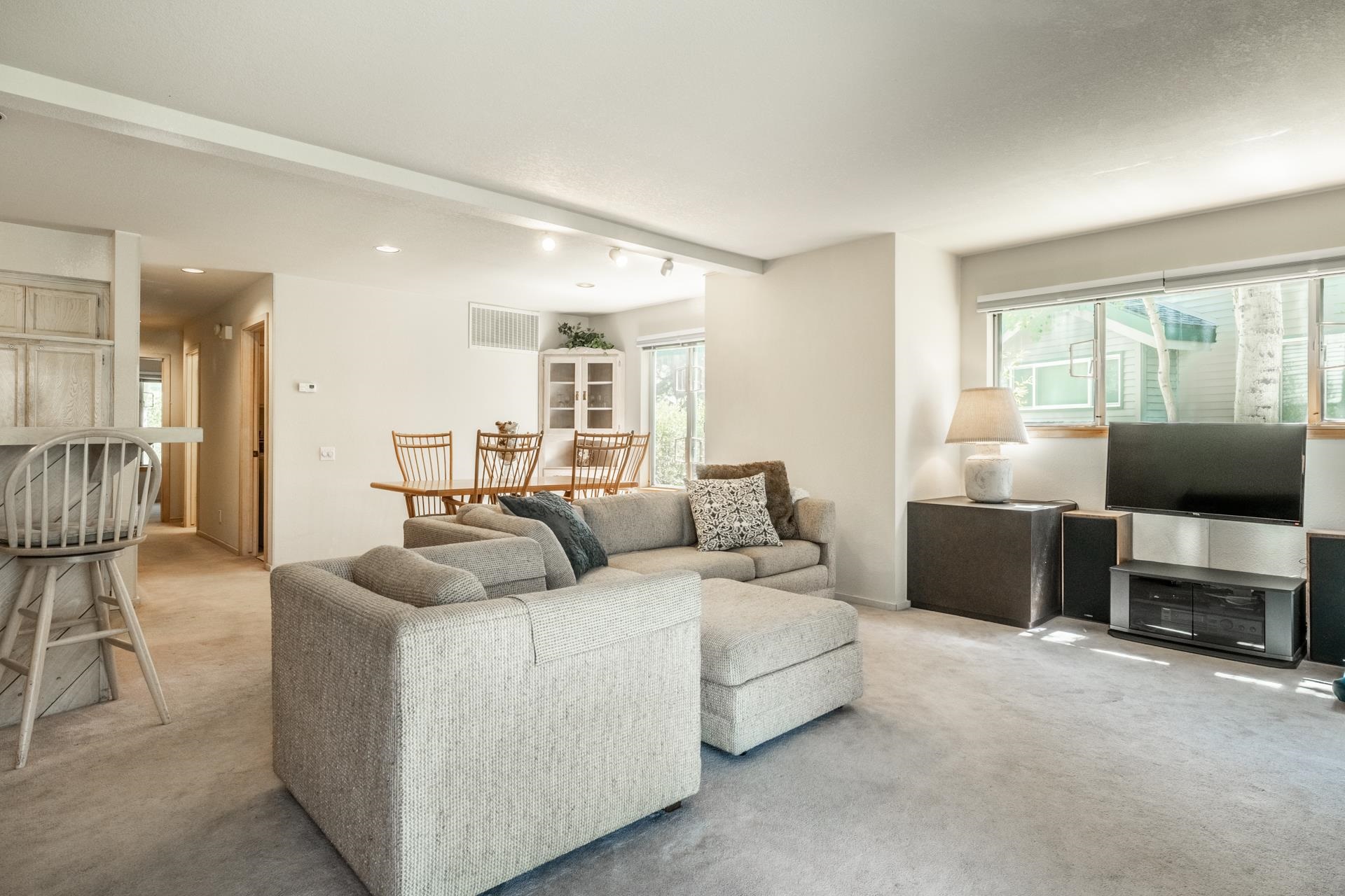 609 Golden Creek Road, Unit 609 Mammoth Lakes, CA 93546 - Photo 20 of 42 Expansive living area featuring light-toned carpeting and abundant natural light from multiple windows