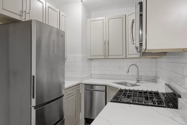 a kitchen with stainless steel appliances a refrigerator and a sink