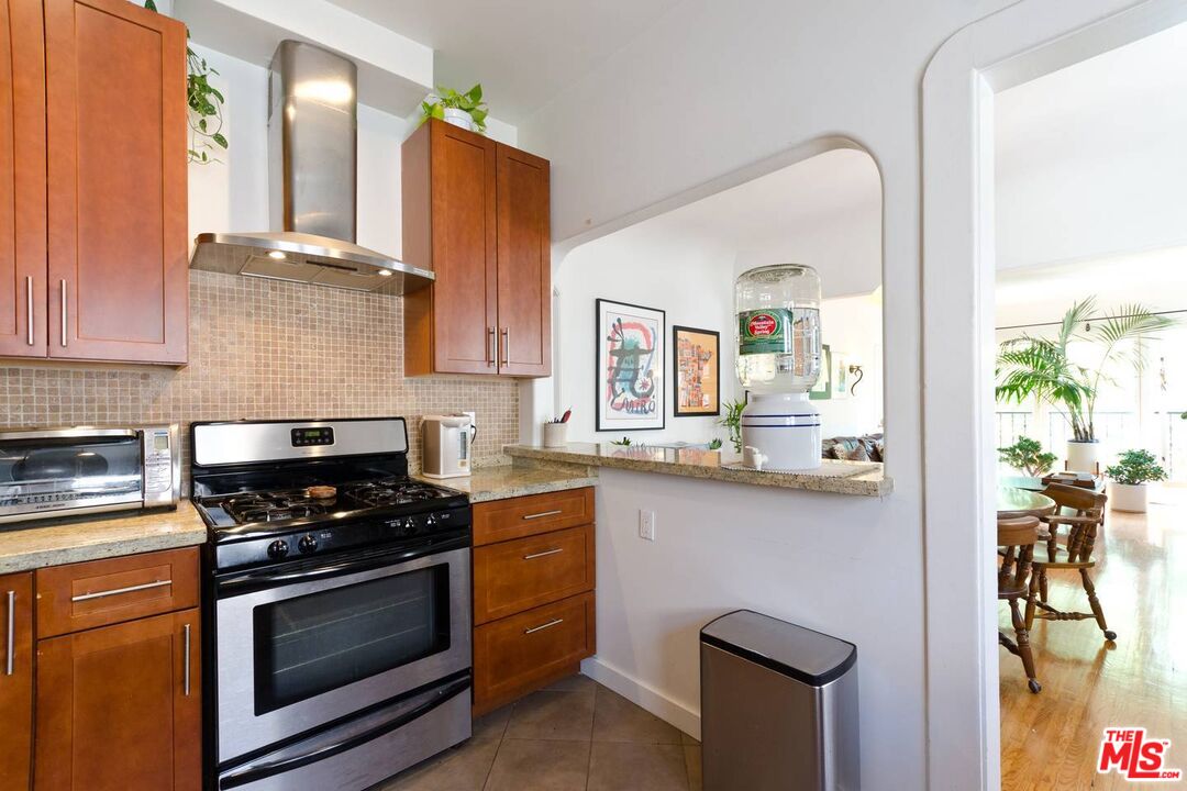 506 North Spaulding Avenue Los Angeles, CA 90036 - Photo 11 of 23 a kitchen with stainless steel appliances a stove a sink and a microwave