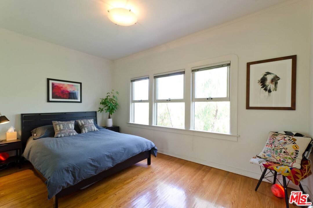 506 North Spaulding Avenue Los Angeles, CA 90036 - Photo 12 of 23 a bedroom with a bed and wooden floor