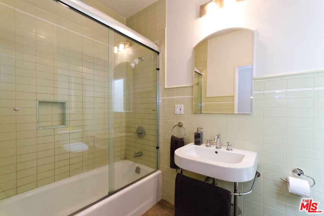 506 North Spaulding Avenue Los Angeles, CA 90036 - Photo 15 of 23 a bathroom with a sink and a mirror