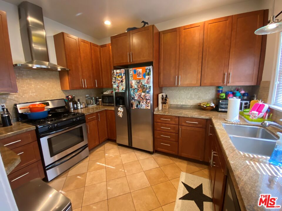 506 North Spaulding Avenue Los Angeles, CA 90036 - Photo 19 of 23 a kitchen with granite countertop a stove top oven sink and cabinets