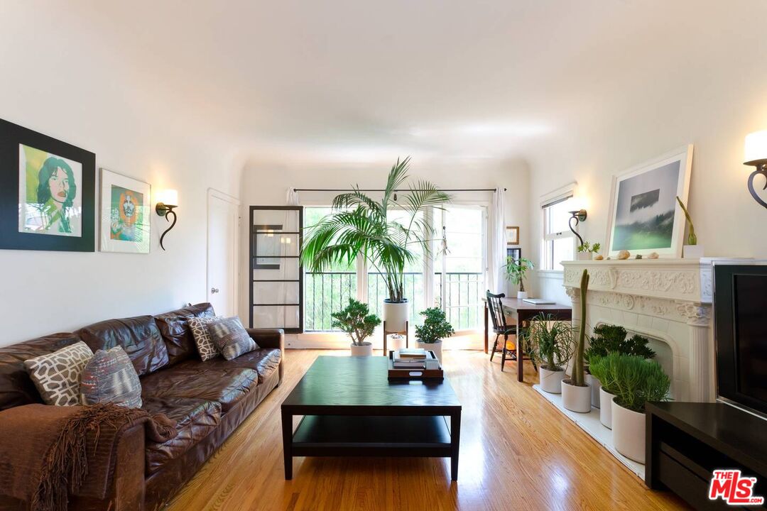 506 North Spaulding Avenue Los Angeles, CA 90036 - Photo 5 of 23 a living room with furniture potted plant a fireplace and a large window