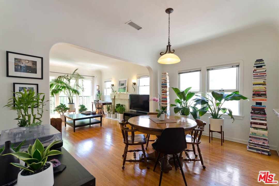 506 North Spaulding Avenue Los Angeles, CA 90036 - Photo 7 of 23 a dining room with furniture potted plants and wooden floor