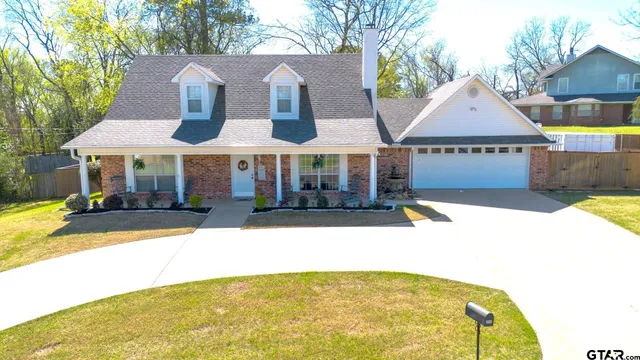 a view of house with outdoor space and sitting area