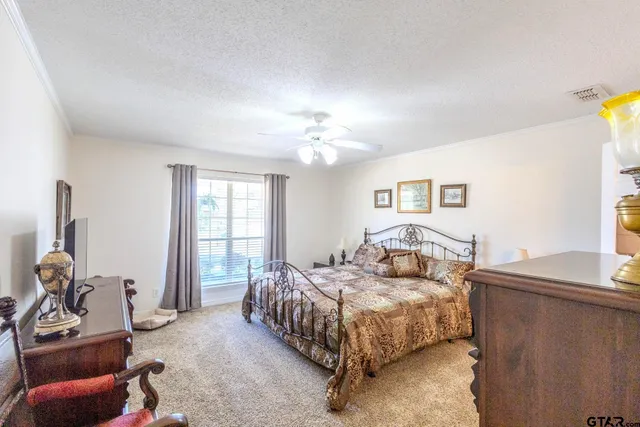 a bedroom with a bed couch and a window