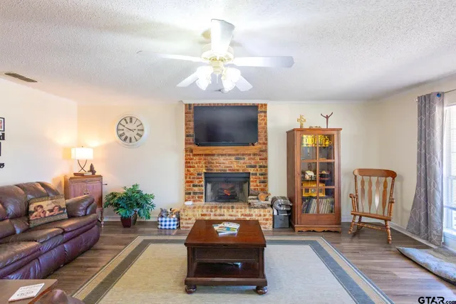 a living room with furniture a fireplace and a flat screen tv
