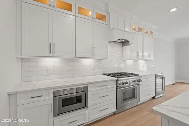 a kitchen with white cabinets and appliances
