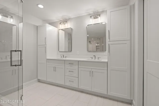 a spacious bathroom with a double vanity sink and mirror