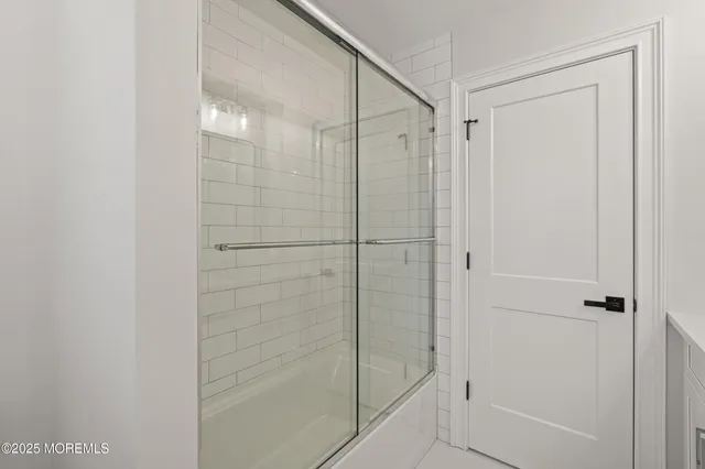 a bathroom with a glass shower door