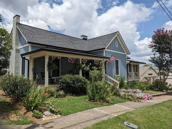 a front view of a house with garden