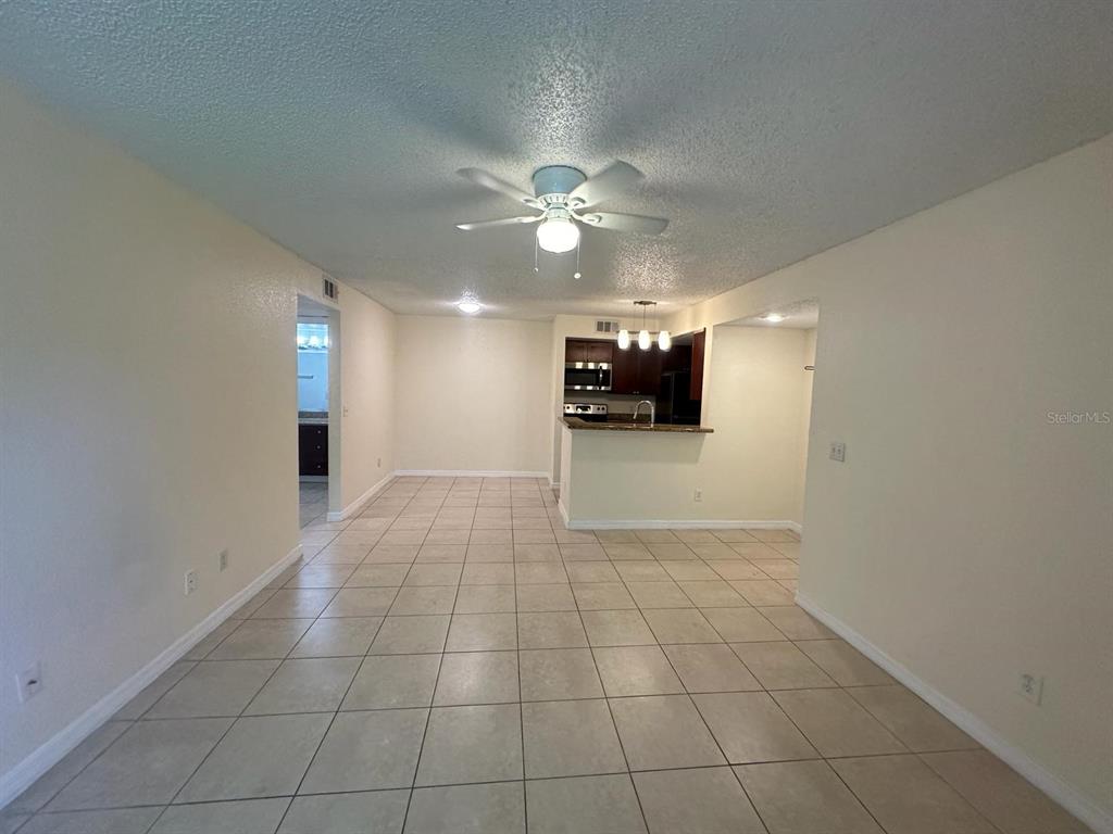5120 Conroy Road, Unit 13 Orlando, FL 32811 - Photo 4 of 21 a view of an empty room and a kitchen