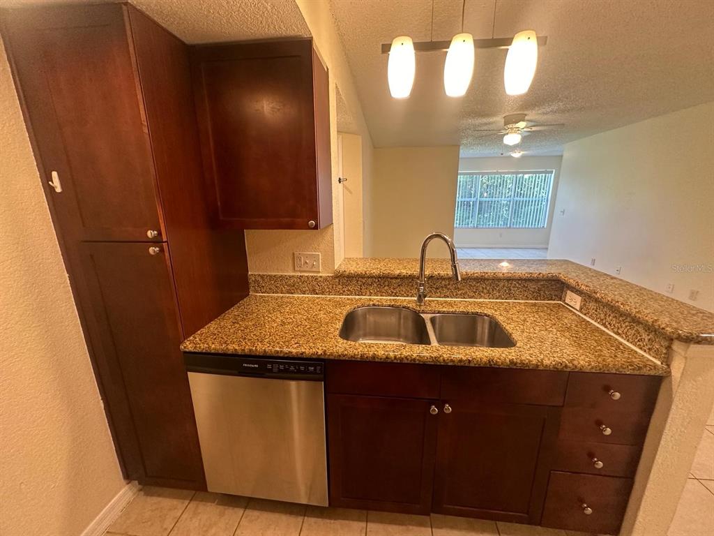 5120 Conroy Road, Unit 13 Orlando, FL 32811 - Photo 7 of 21 a kitchen with a sink and a mirror