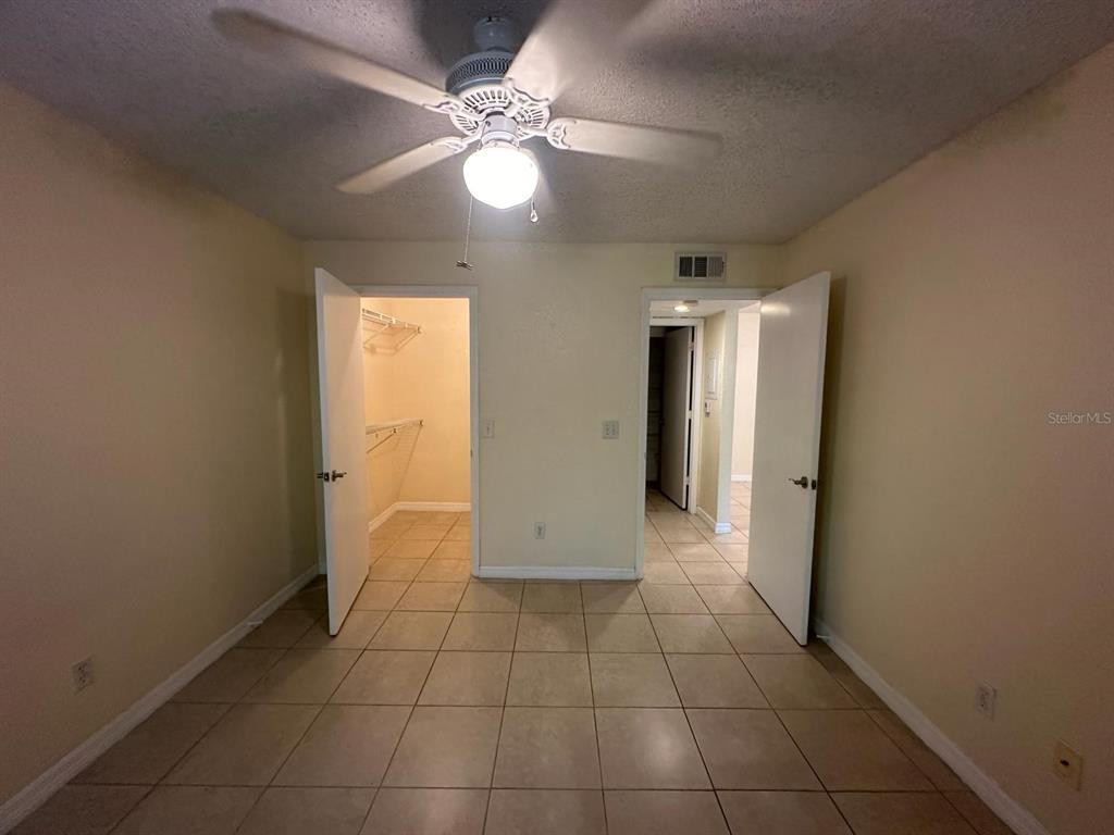 5120 Conroy Road, Unit 13 Orlando, FL 32811 - Photo 9 of 21 an empty room with fan and entrance