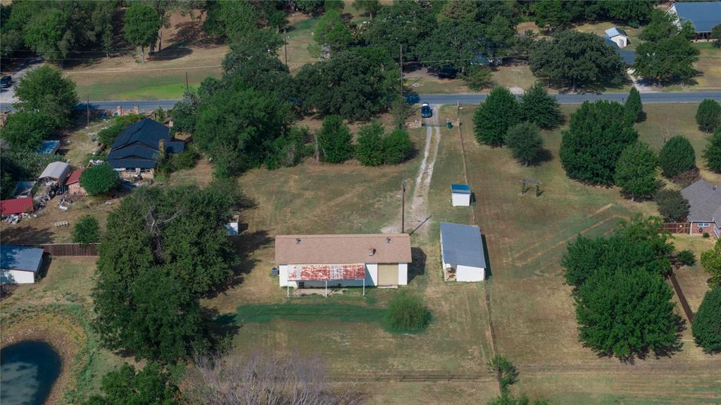 1214 Desvoignes Road Denison, TX 75021 - Photo 20 of 20 Expansive lot with mature trees, a private pond, and multiple outbuildings