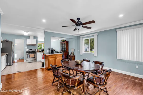 a view of a dining room with furniture and wooden floor
