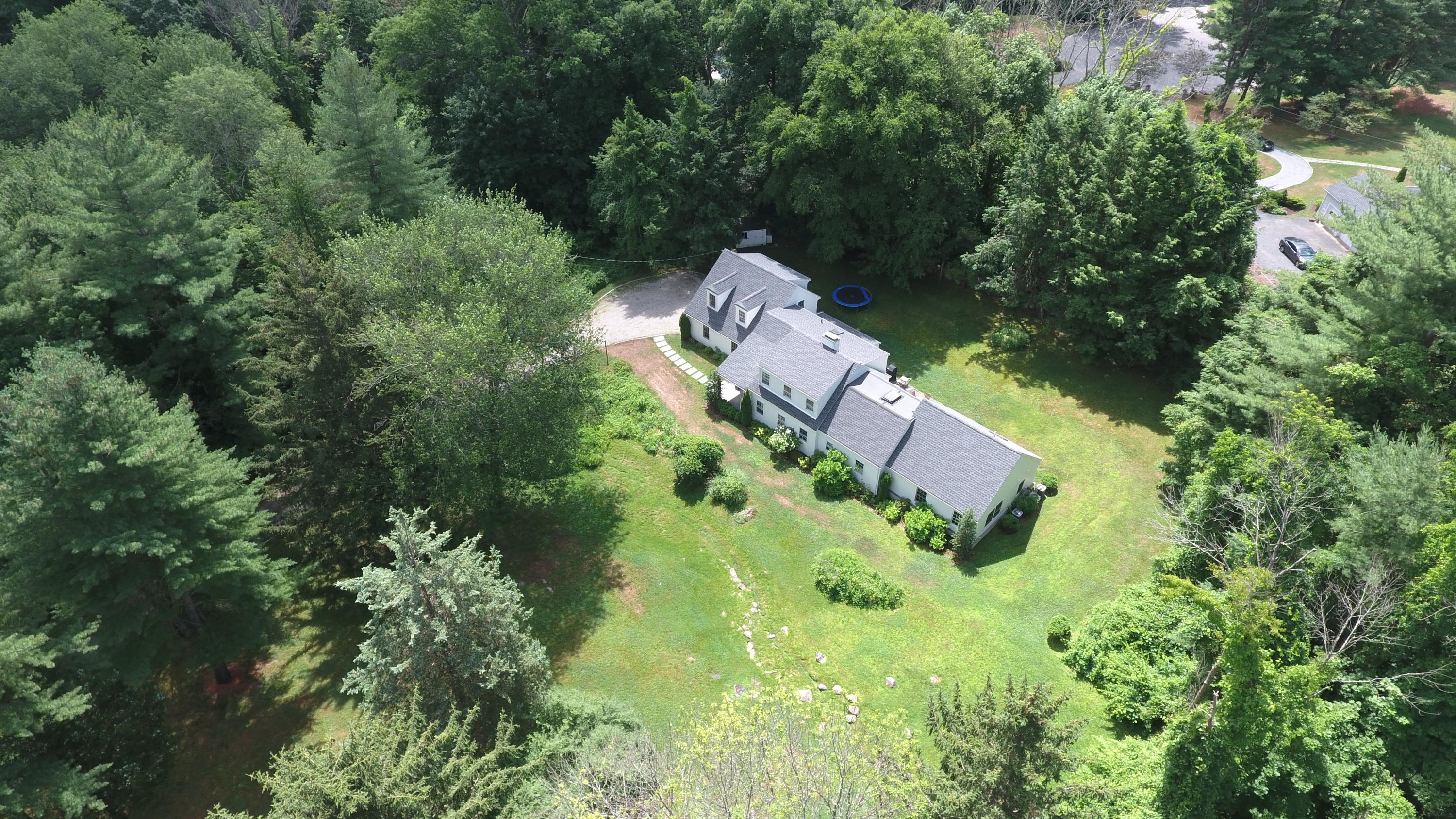 61 Juniper Road New Canaan, CT 06840 - Photo 1 of 17 an aerial view of a house with pool outdoor space and trees all around