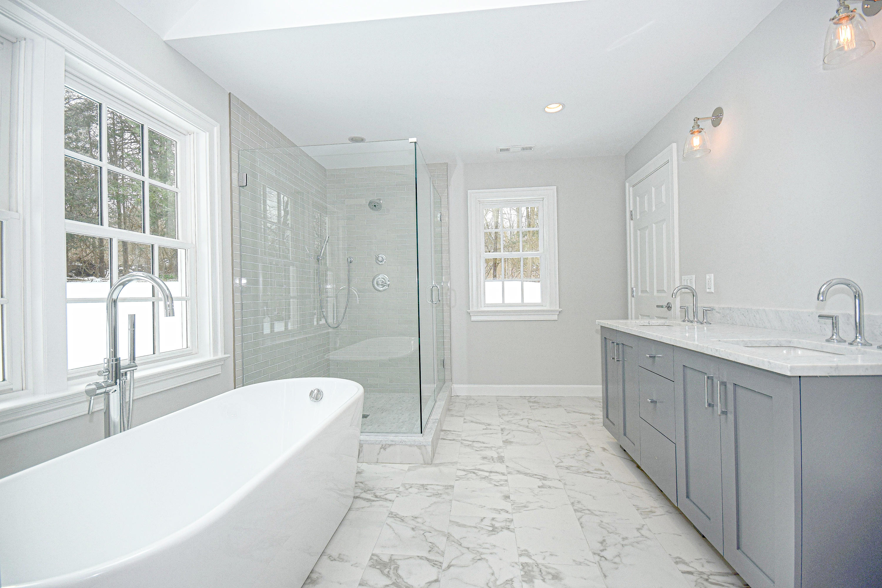 61 Juniper Road New Canaan, CT 06840 - Photo 12 of 17 a spacious bathroom with a tub sink shower and mirror