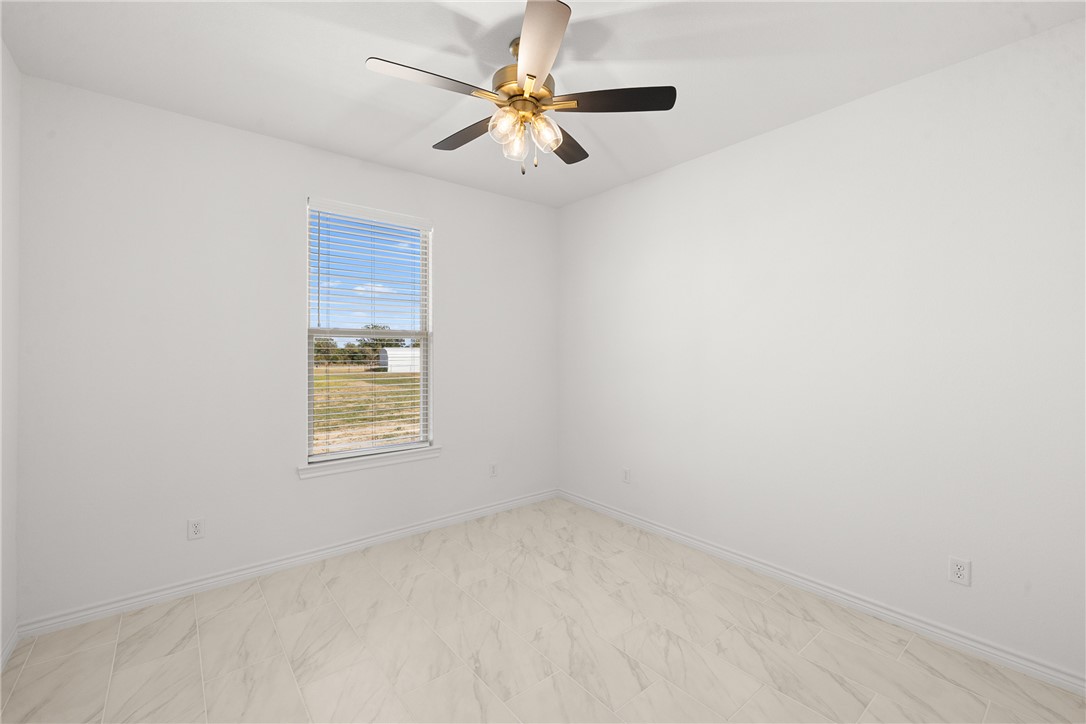 6512 Agave Court Bryan, TX 77808 - Photo 35 of 42 Unfurnished room featuring baseboards and ceiling fan