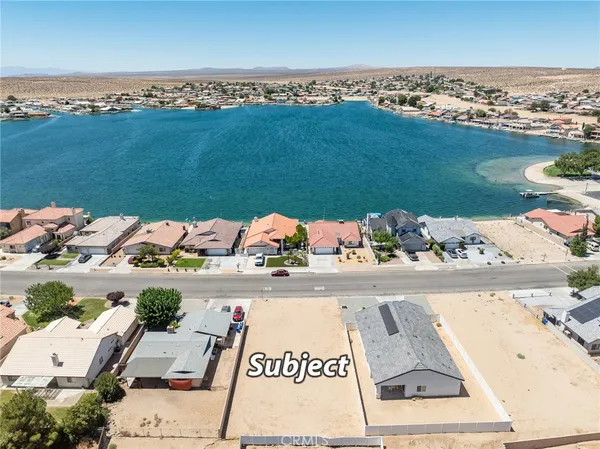 an aerial view of a house with a ocean view