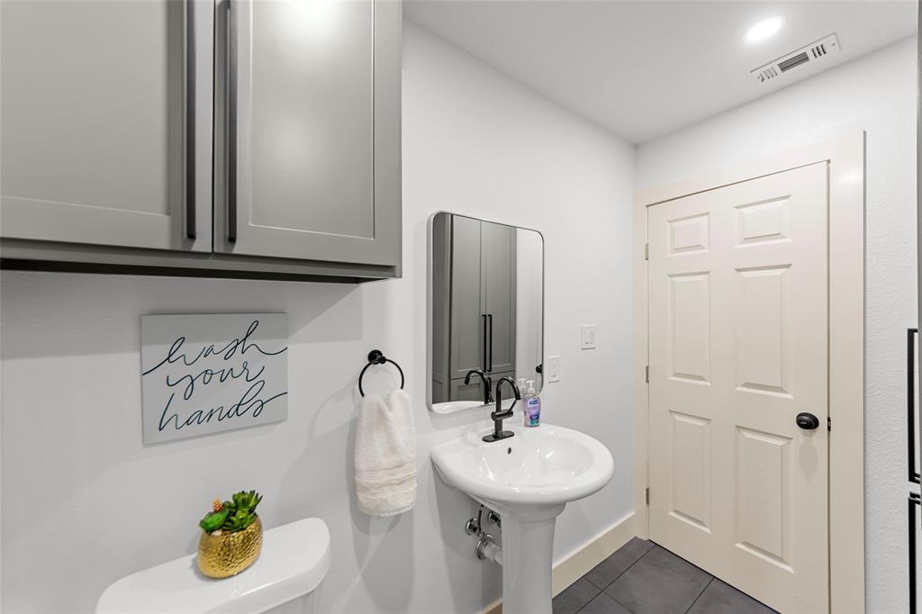 2945 Healey Drive Dallas, TX 75228 - Photo 15 of 38 a bathroom with a sink and a mirror