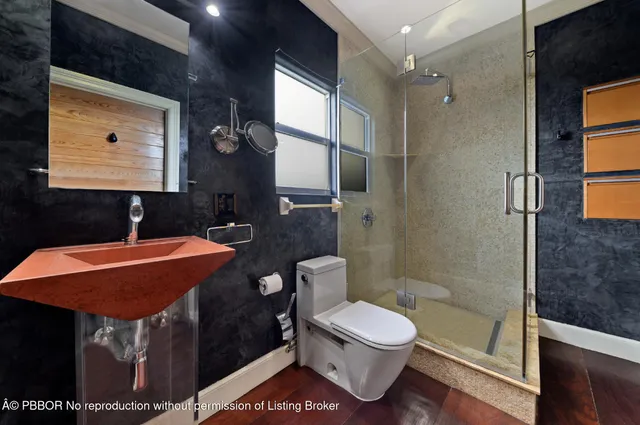 a bathroom with a toilet sink and shower