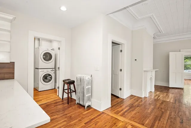 a view of a bedroom with a bed and wooden floor