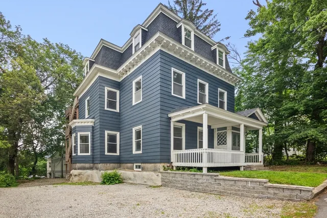 a front view of a house with a garden