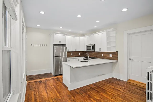 a kitchen with stainless steel appliances a sink and refrigerator