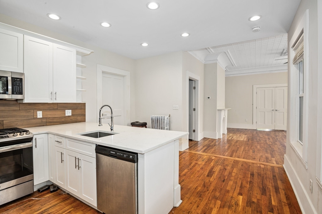 35 Oak Avenue, Unit 1 Worcester, MA 01605 - Photo 6 of 25 a kitchen with a sink stove and white cabinets