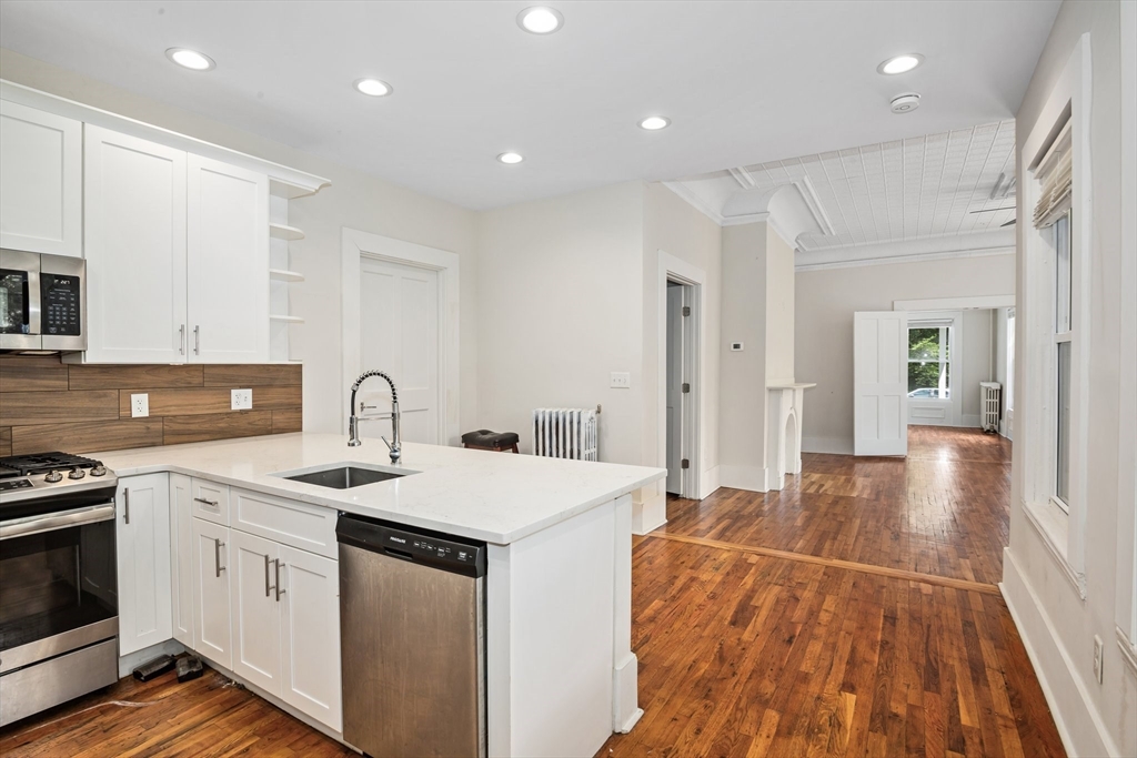 35 Oak Avenue, Unit 1 Worcester, MA 01605 - Photo 7 of 25 a kitchen with a sink stove and cabinets