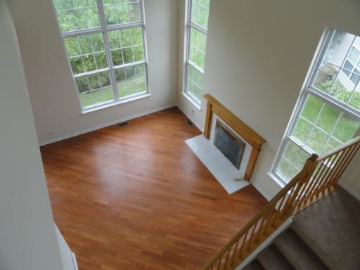 2 Grandview Court, Unit 2 Algonquin, IL 60102 - Photo 2 of 5 an empty room with wooden floor and windows