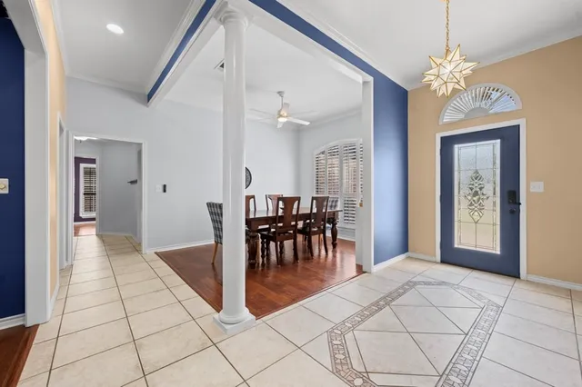a view of a dining room with furniture and chandelier