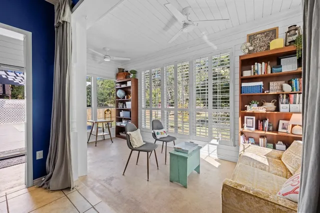 a living room with furniture and a book shelf