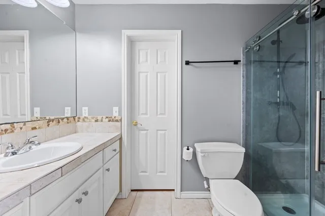a bathroom with a sink toilet and shower