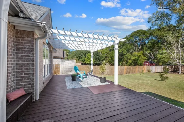 a view of a deck with couches with wooden floor and fence