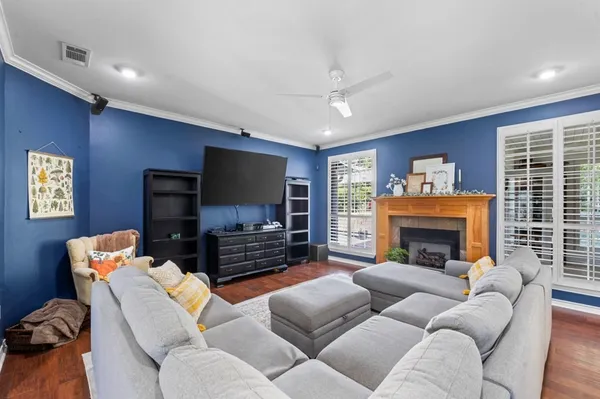 a living room with furniture a flat screen tv and a fireplace