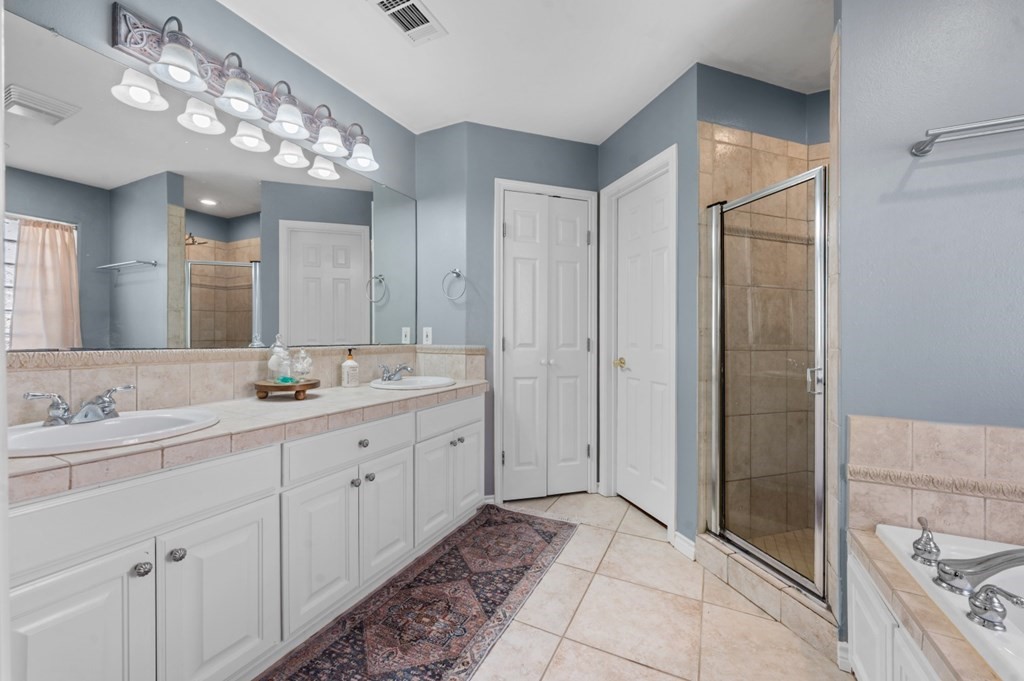 365 Copperfield Loop Lufkin, TX 75904 - Photo 9 of 28 a spacious bathroom with a double vanity sink mirror and shower