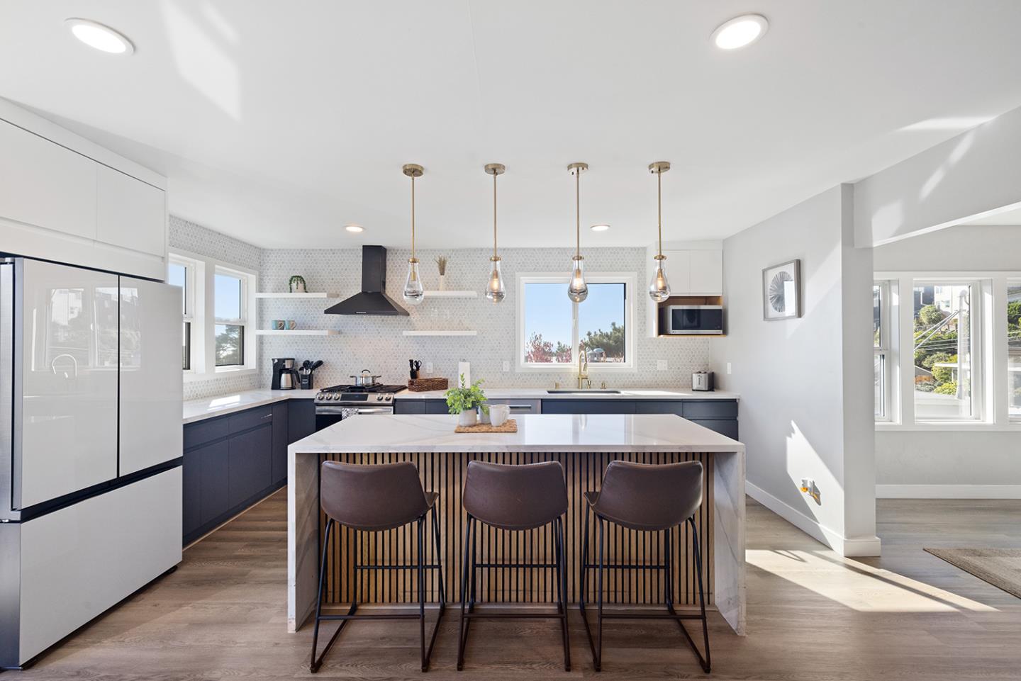 488 Monterey Road Pacifica, CA 94044 - Photo 28 of 78 a kitchen with stainless steel appliances granite countertop a dining table chairs stove refrigerator and cabinets