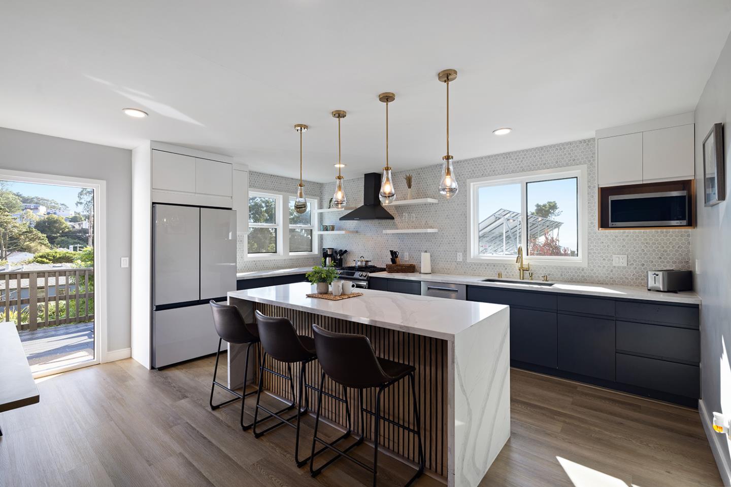 488 Monterey Road Pacifica, CA 94044 - Photo 29 of 78 a kitchen with stainless steel appliances granite countertop a sink a stove a refrigerator and island with wooden floor