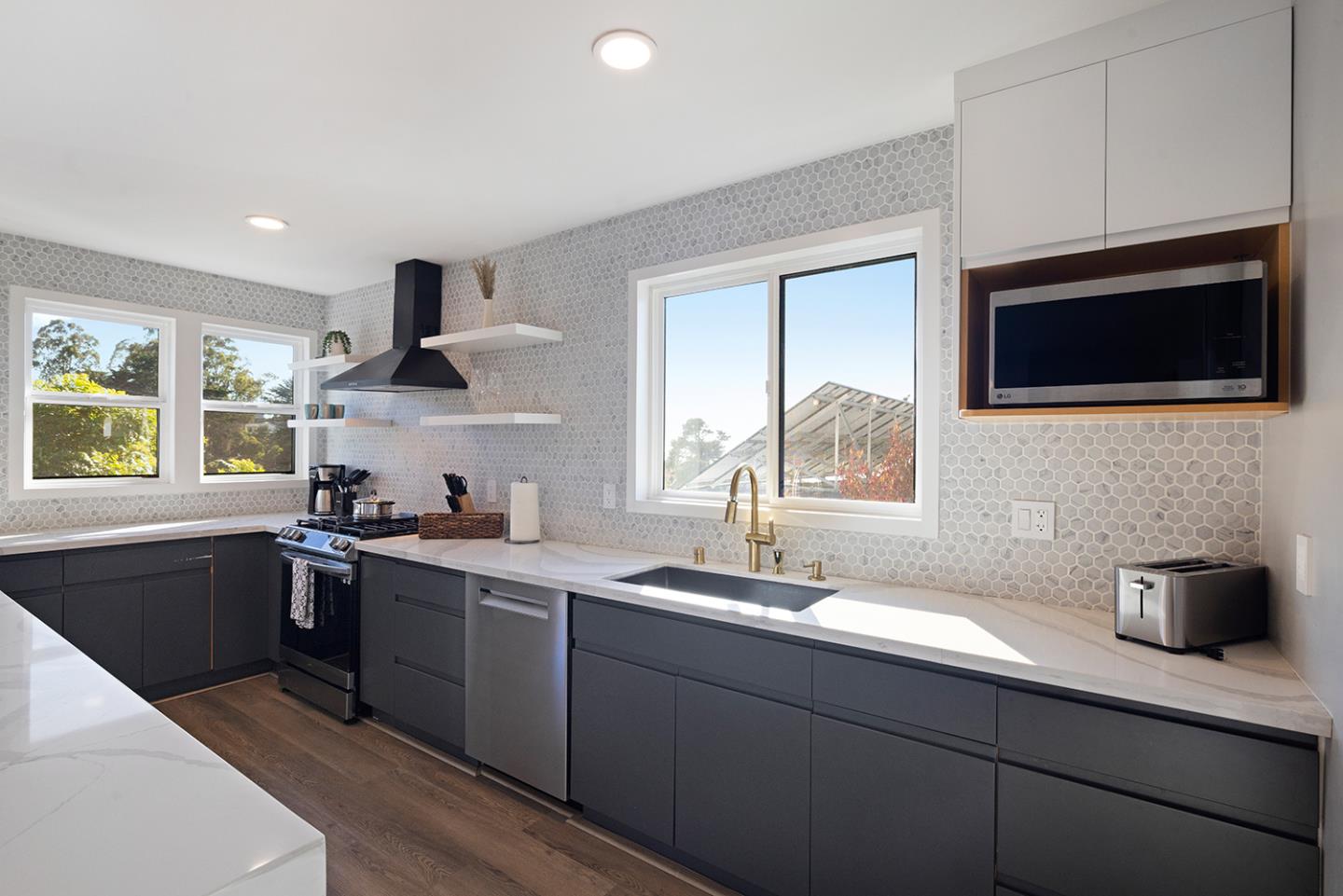 488 Monterey Road Pacifica, CA 94044 - Photo 30 of 78 a kitchen with stainless steel appliances granite countertop a sink a stove a microwave a window and cabinets