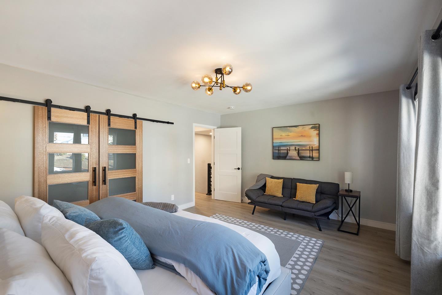 488 Monterey Road Pacifica, CA 94044 - Photo 41 of 78 a bedroom with a bed and a chandelier