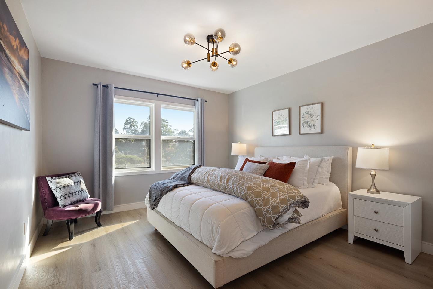 488 Monterey Road Pacifica, CA 94044 - Photo 42 of 78 a bedroom with a bed and a chandelier